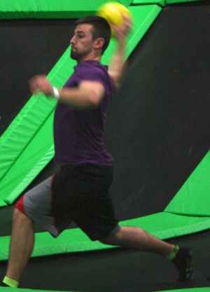 Man Playing Area Dodgeball on a Trampoline