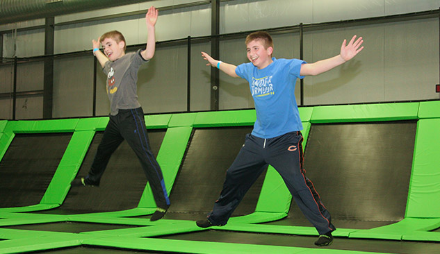 2 kids trampolining in sync