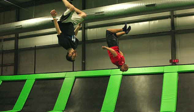 Teenagers doing flips on the trampolines