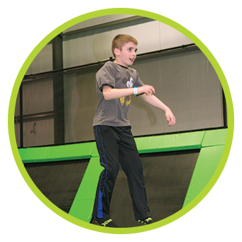 Family fun at trampoline park Young man jumping